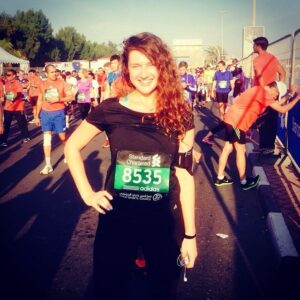 Elena standing proudly at the finish line after completing her 10k Dubai Marathon journey | The Hundred Pilates Studio